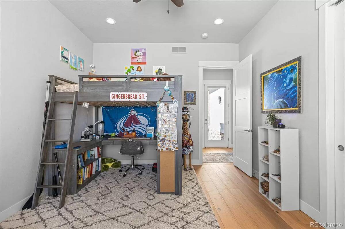 Bedroom with a loft bed over the patterned area rug.