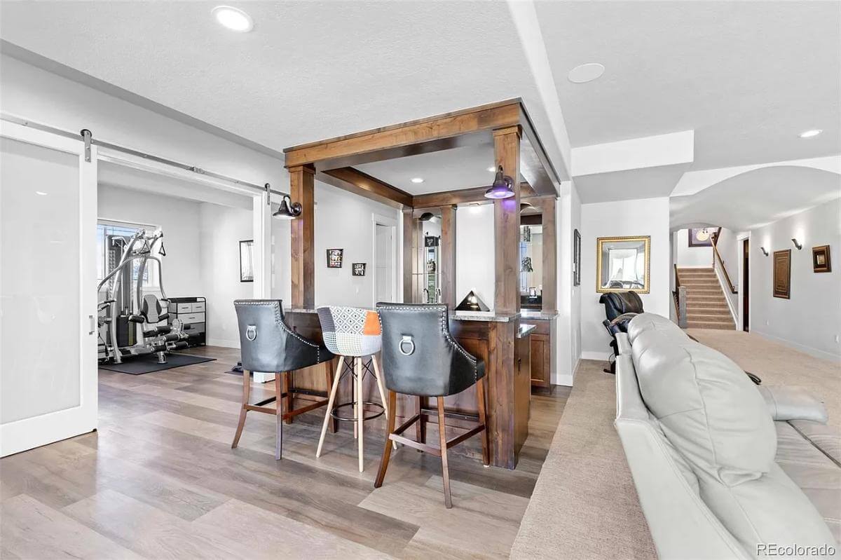 Wet bar with a raised counter and seating for three.