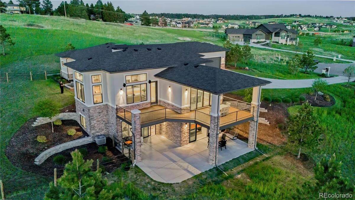 Aerial rear view of the contemporary ranch.