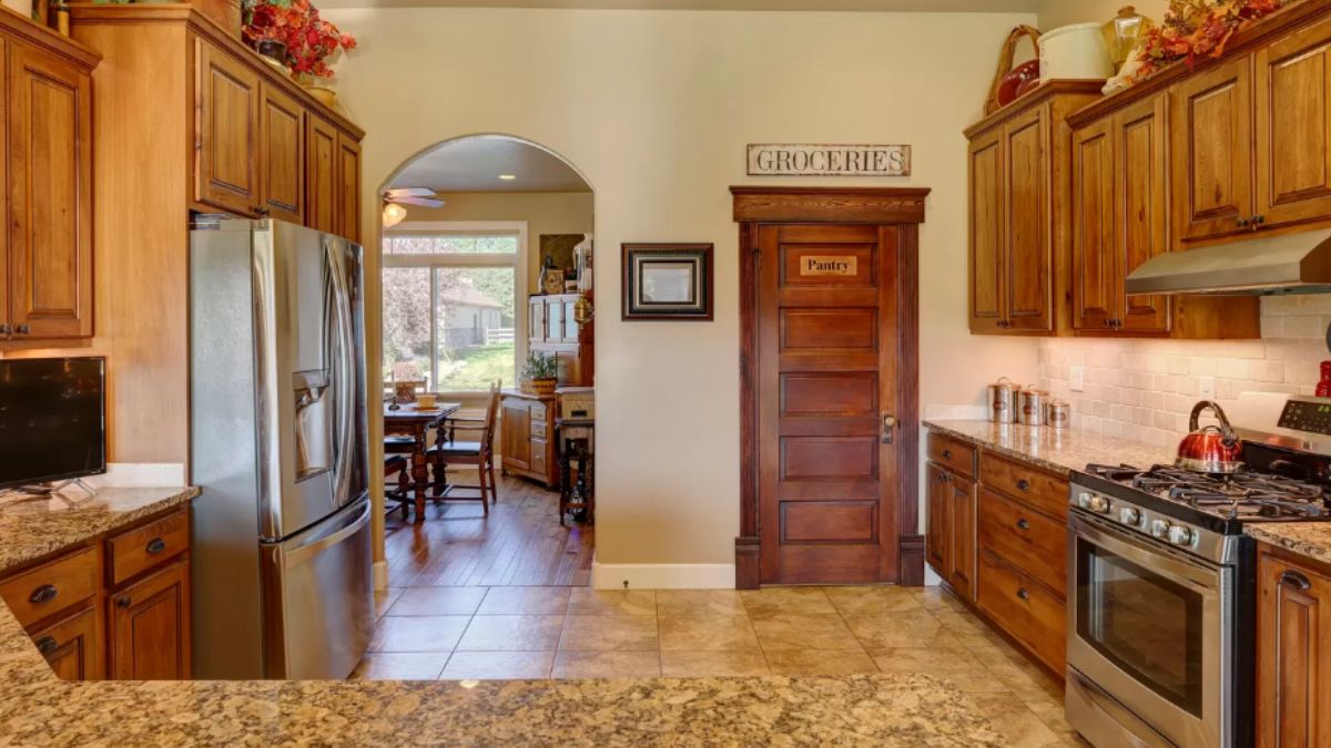 A kitchen with countertops, cabinets, and kitchen appliances.