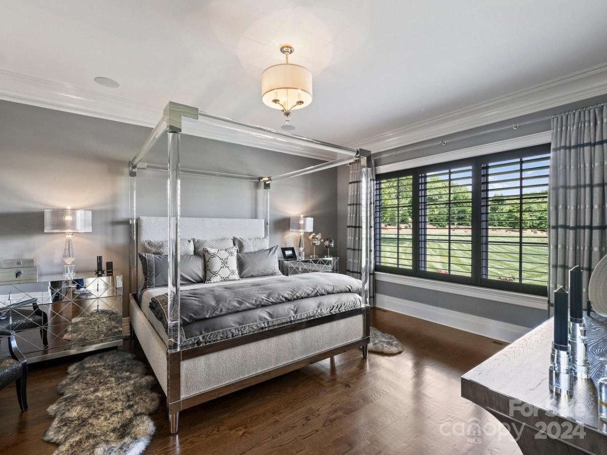 Bedroom with a large bed and hardwood flooring.