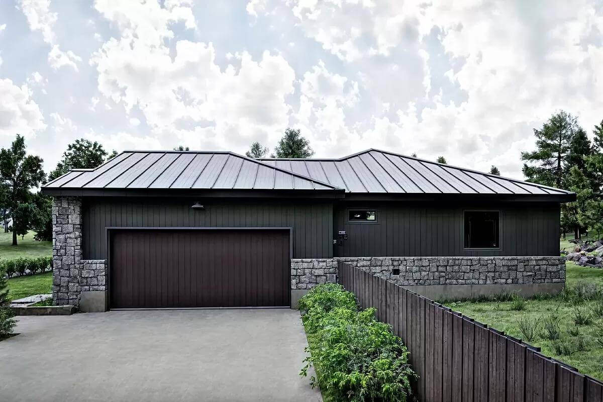 Garage with dark wood doors and a concrete driveway.