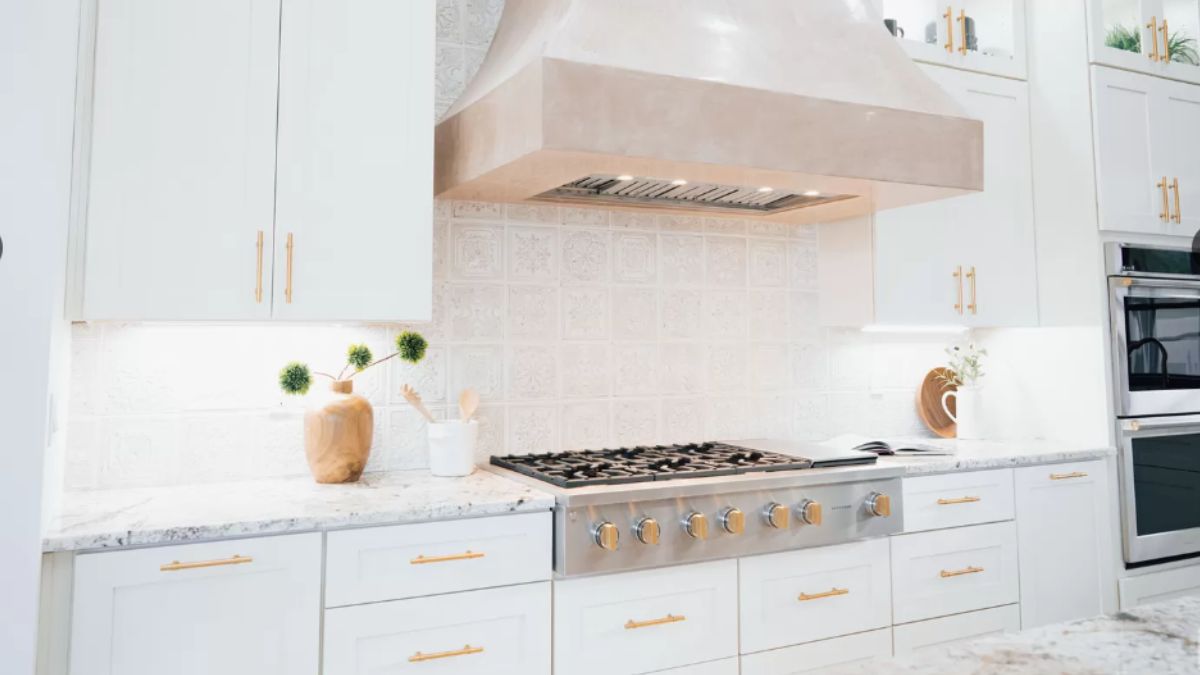 A kitchen with a countertop, cabinets, and a stove.