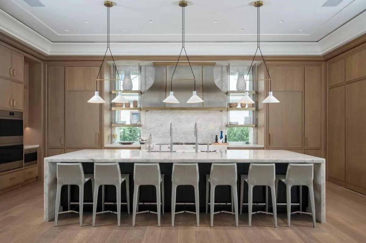 Kitchen with a spacious granite counter breakfast bar and a center island prep area.