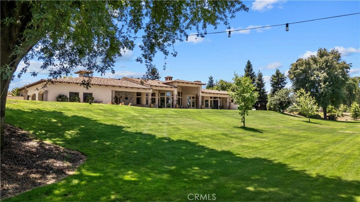 Rear view of the property with a large green lawn.