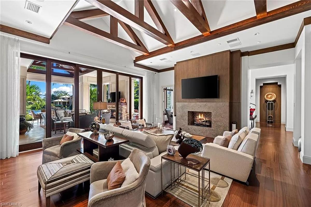 Living room with tables, couches and a fireplace.