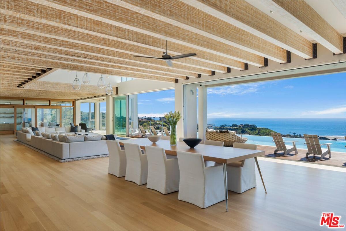 Dining room with a large wood table and chairs.