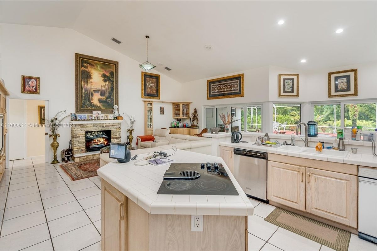 A kitchen with countertops, sink, and cabinets.