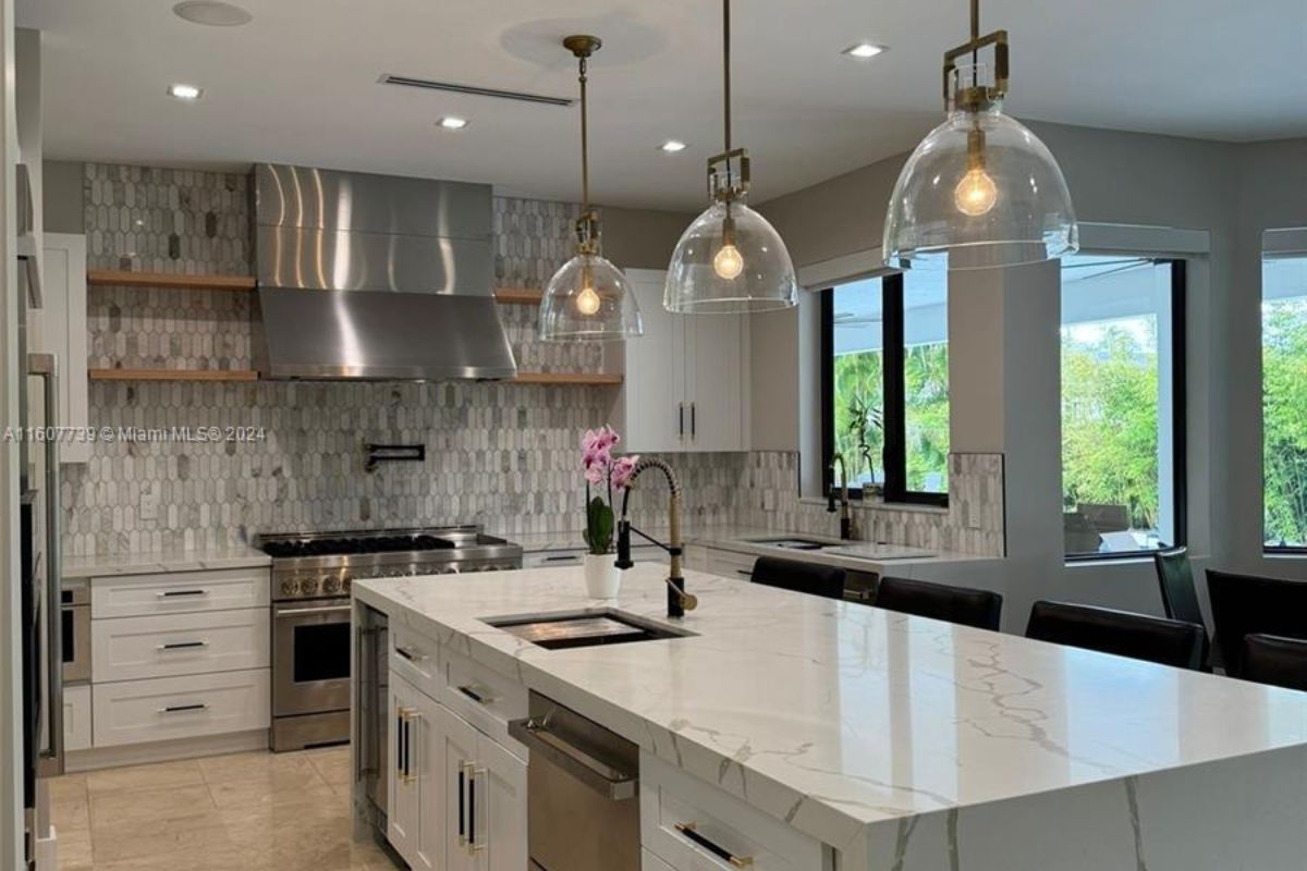 A kitchen with countertops, sink, cabinets, and appliances.