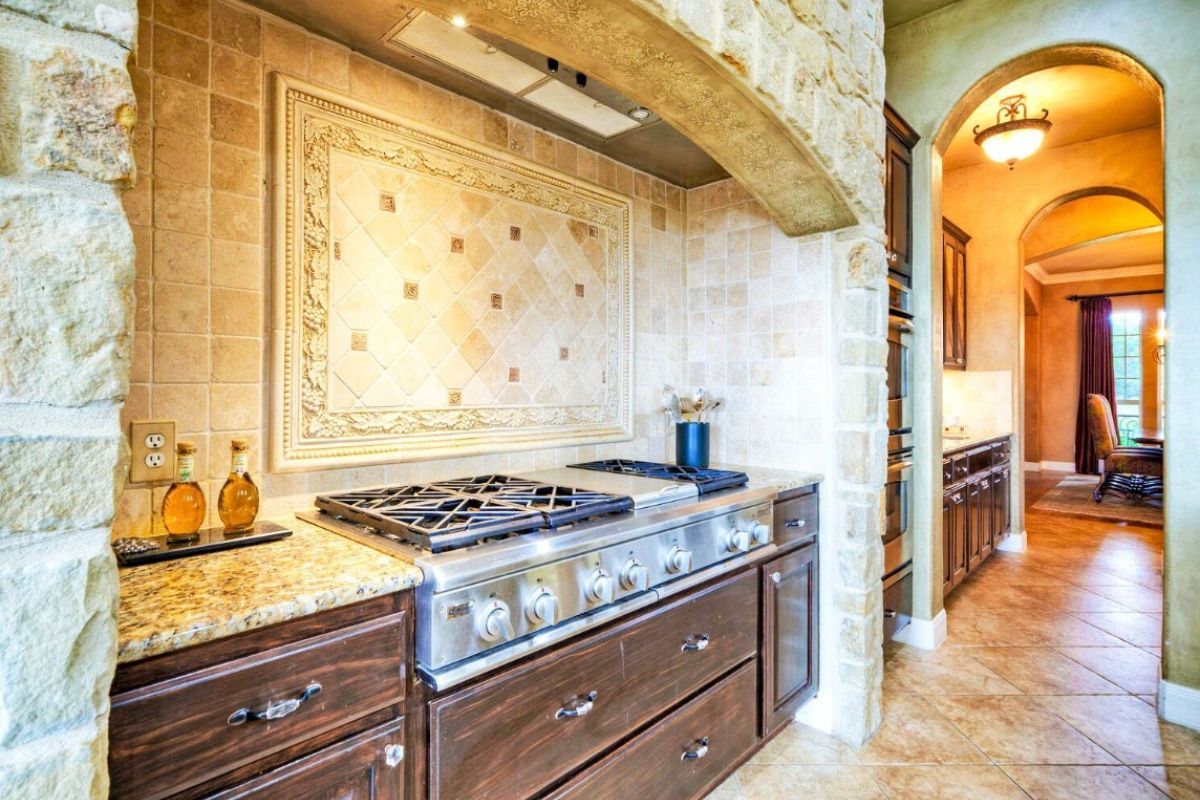 A kitchen with a stove and cabinets.