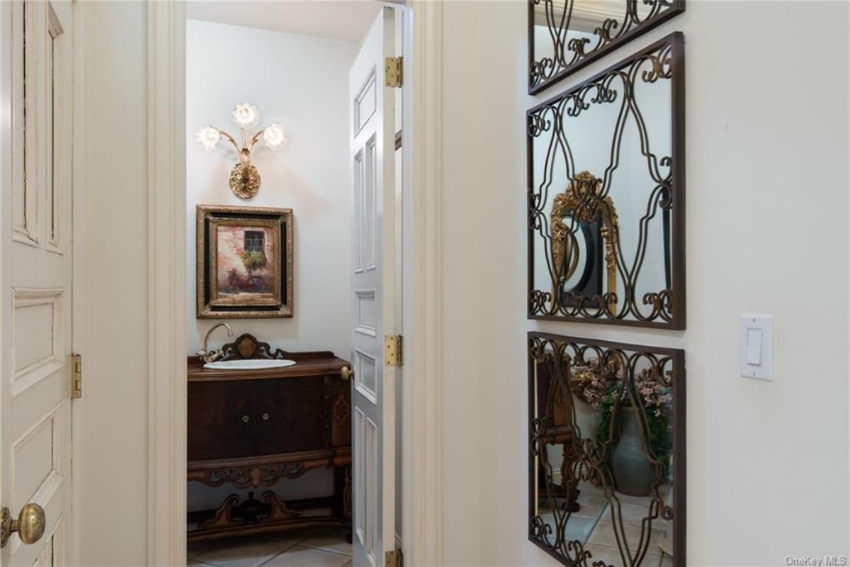 A bathroom with a vanity and a painting.