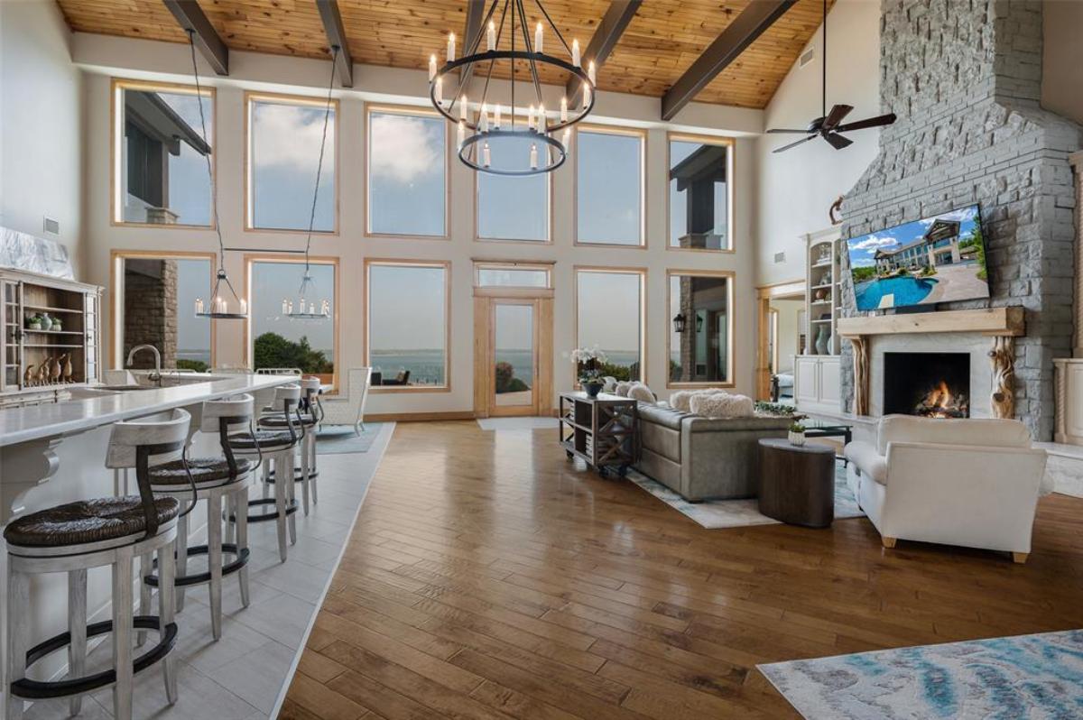 Living room with sofas, couch, fireplace and vaulted ceiling.