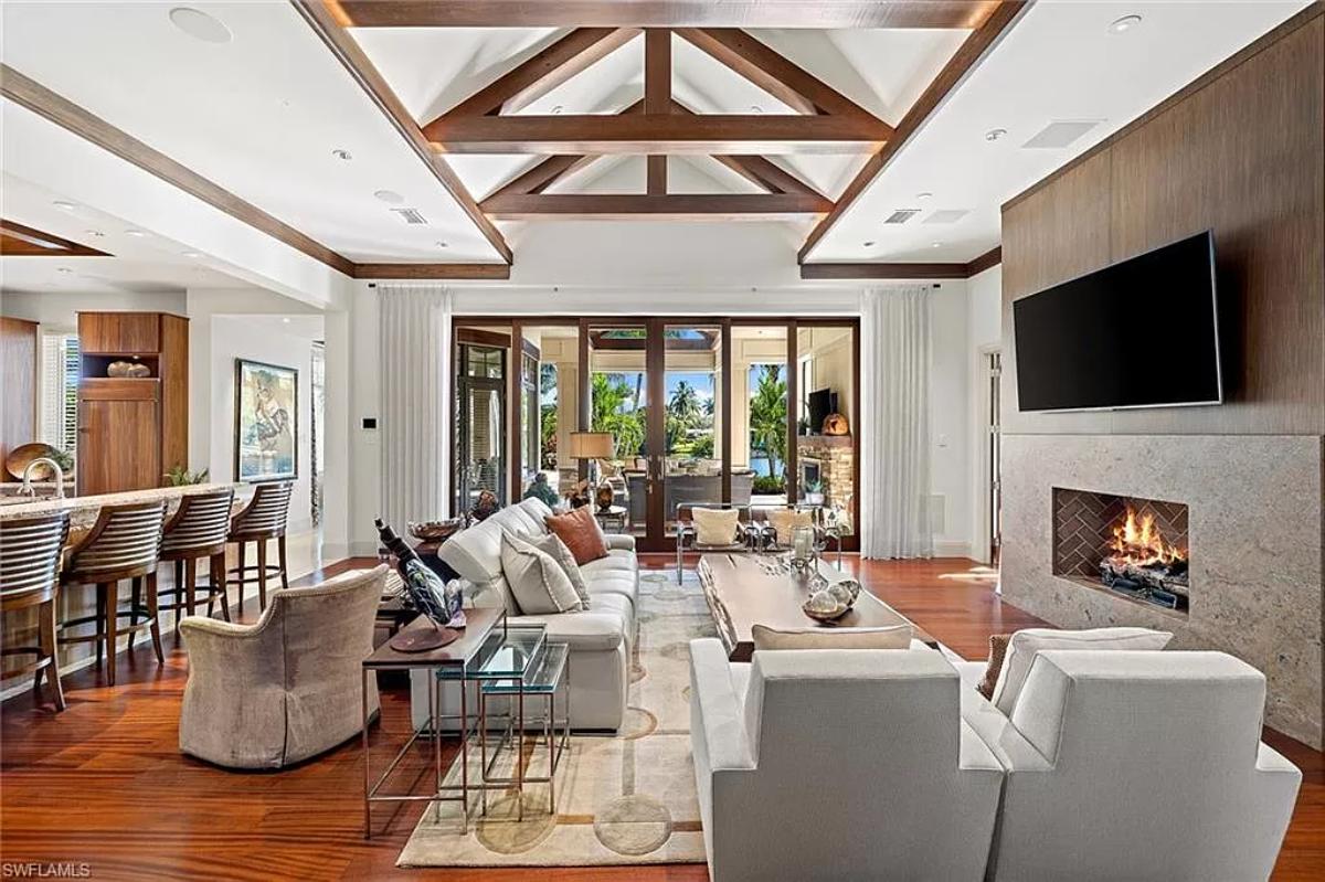 Living room with tables, couches and a fireplace.