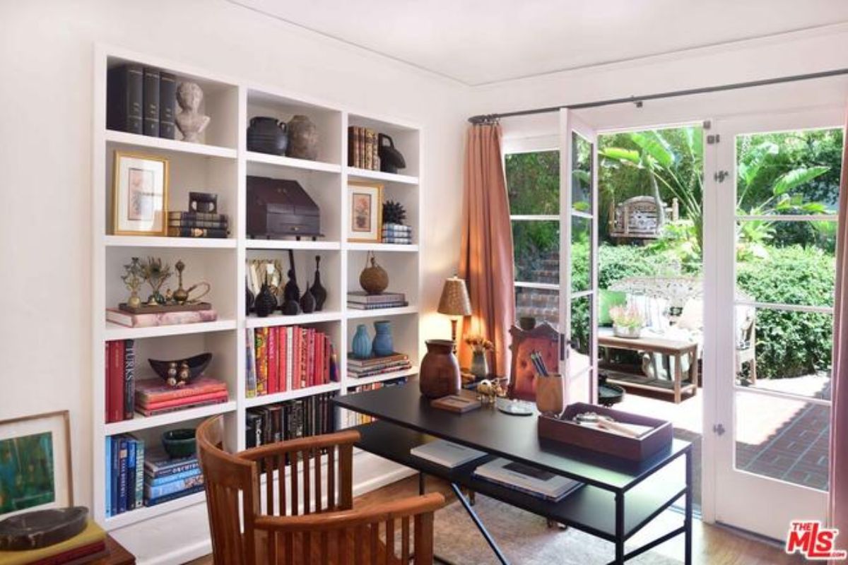 A home office with a shelf, desk, and chair.