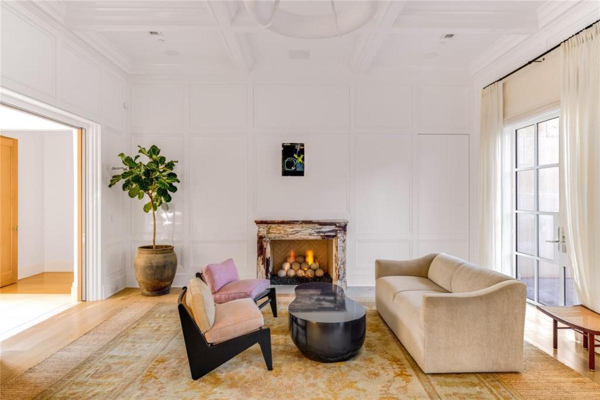 Living room with couches and a fireplace.