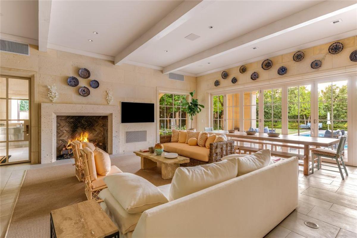 Living room with couches and a fireplace.