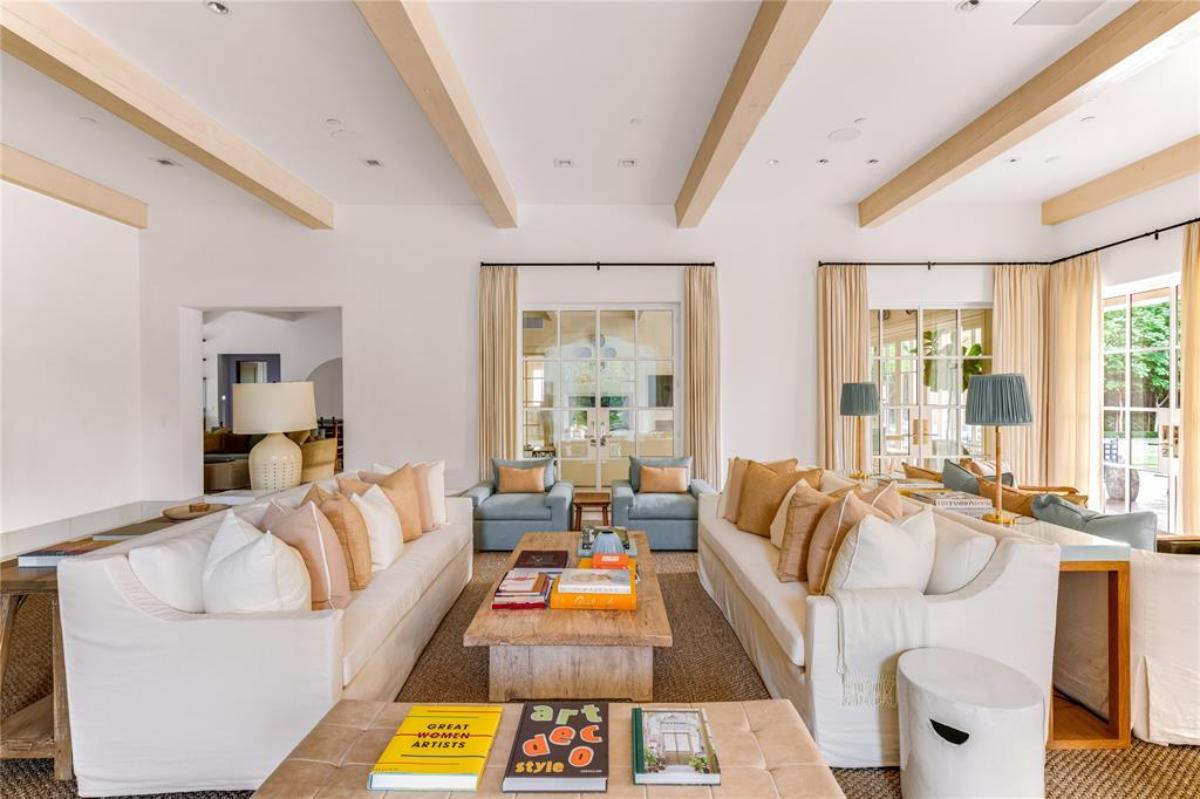 Living room with couches and a vaulted ceiling.