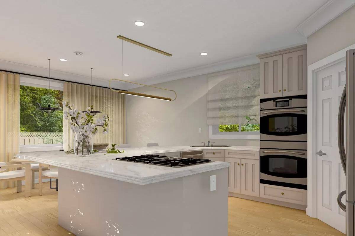 Kitchen with taupe cabinets, marble counters, and a built-in cooktop.