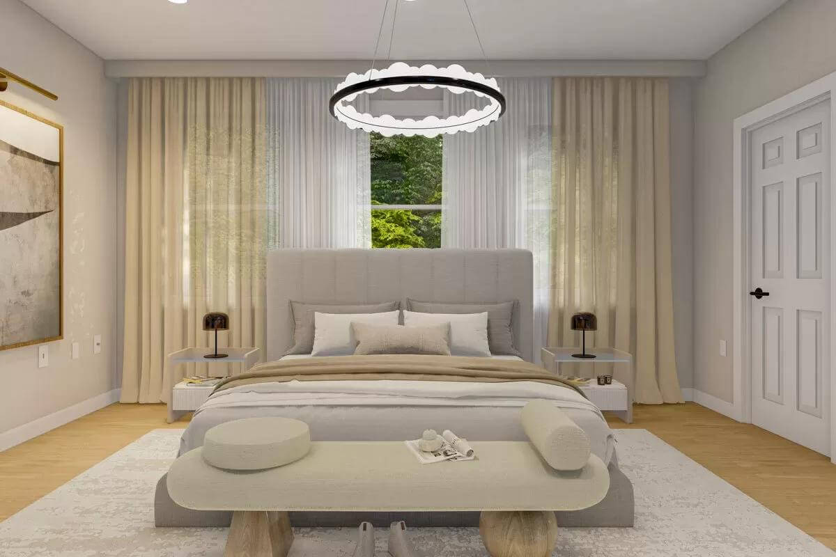 Primary bedroom with an upholstered bed and a cushioned bench illuminated by a round chandelier.