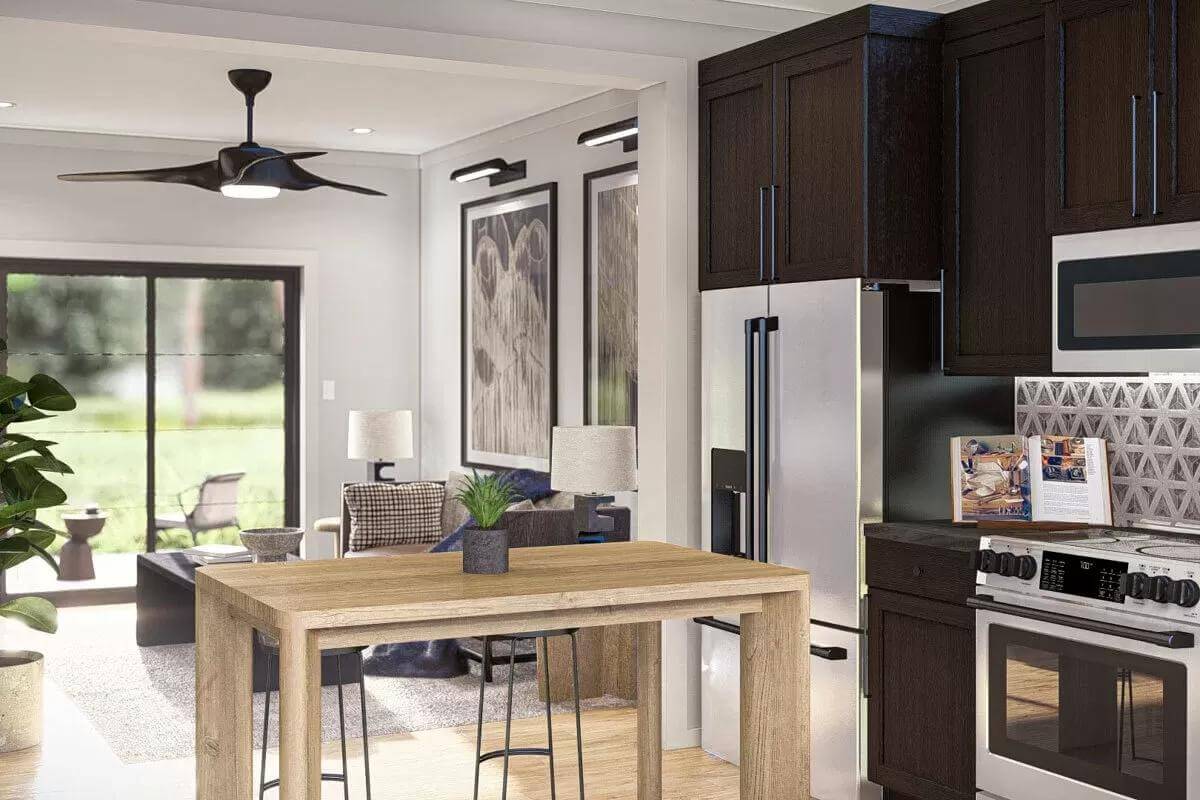 Kitchen with dark wood cabinets and a wooden island overlooking the family room.