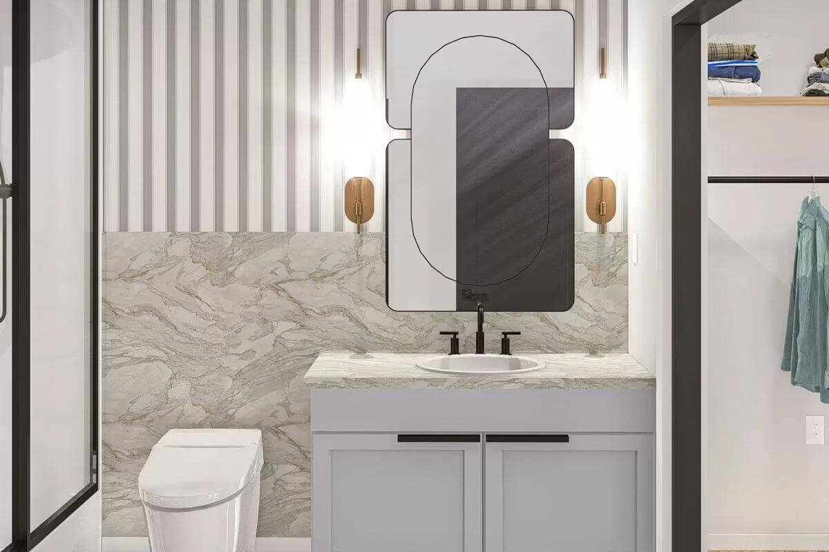 Bathroom with a marble-top vanity paired with a decorative mirror.