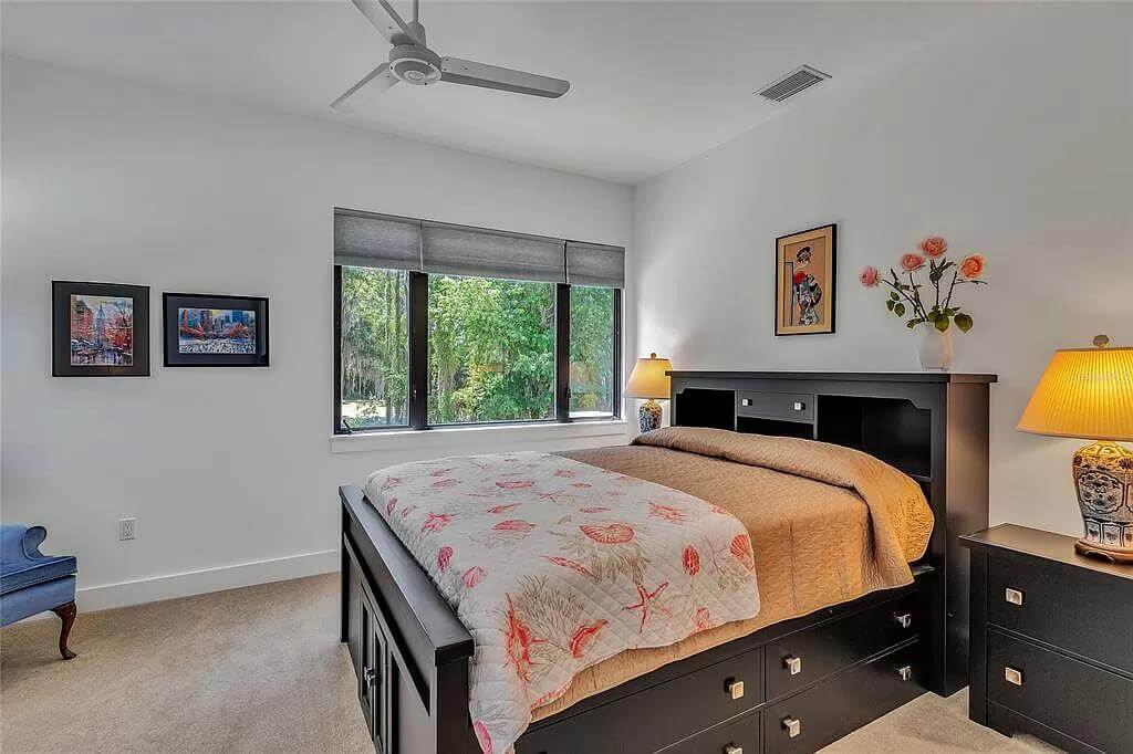 Bedroom with dark wood furnishings over the carpeted floor.