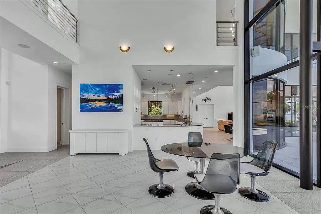 Dining area with a round dining table surrounded by matching chairs.