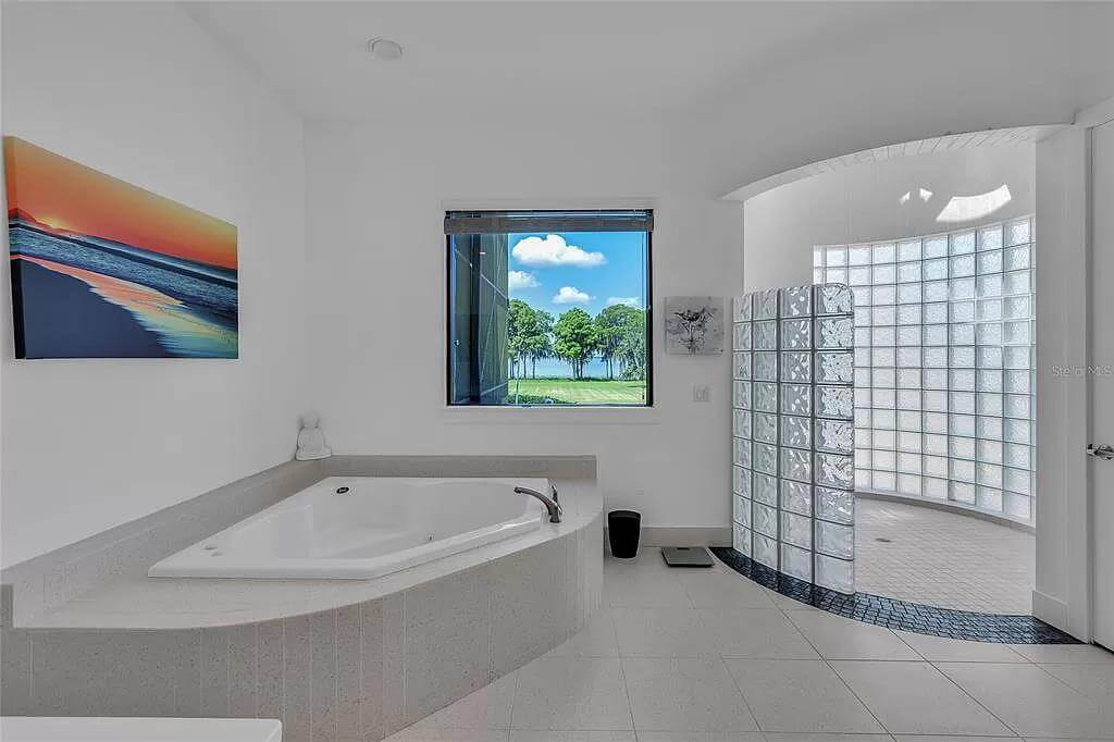 Primary bathroom with a corner tub and a walk-in shower.