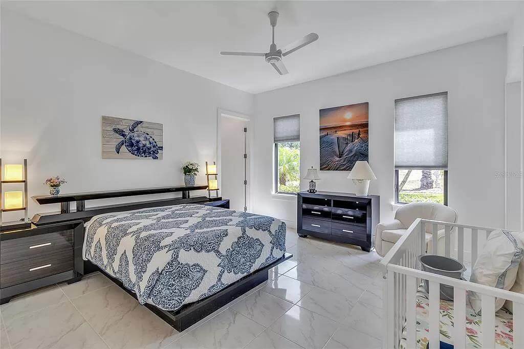 Bedroom with dark wood furnishings over the marble tiled flooring.