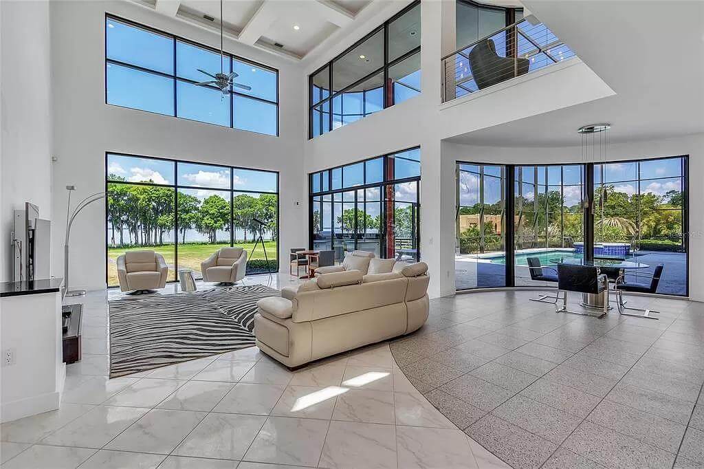 Sitting room with beige seats and a zebra rug over the marble tiled floor.