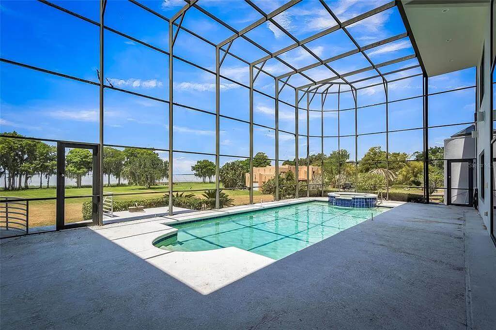 Swimming pool encased in a glass enclosure.