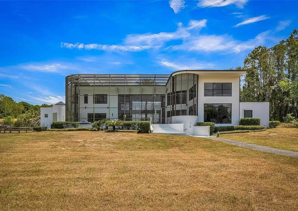 Rear view with huge windows and a covered patio.