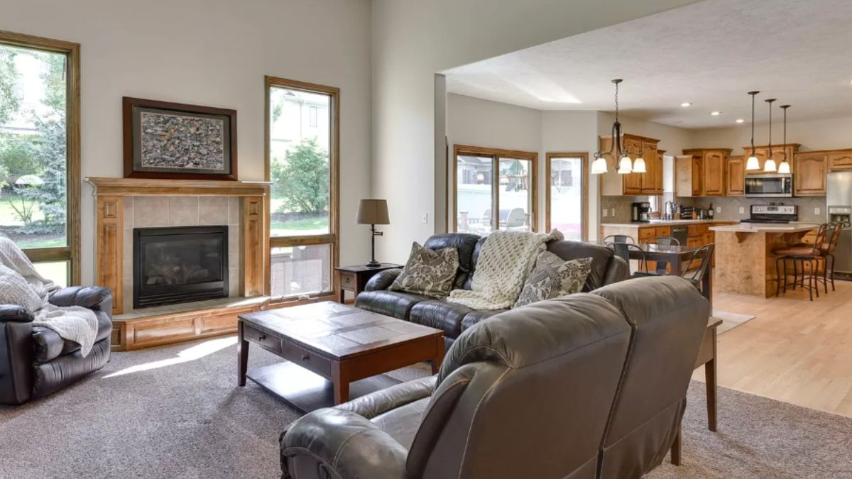 A great room with a living area, dining area, and kitchen.