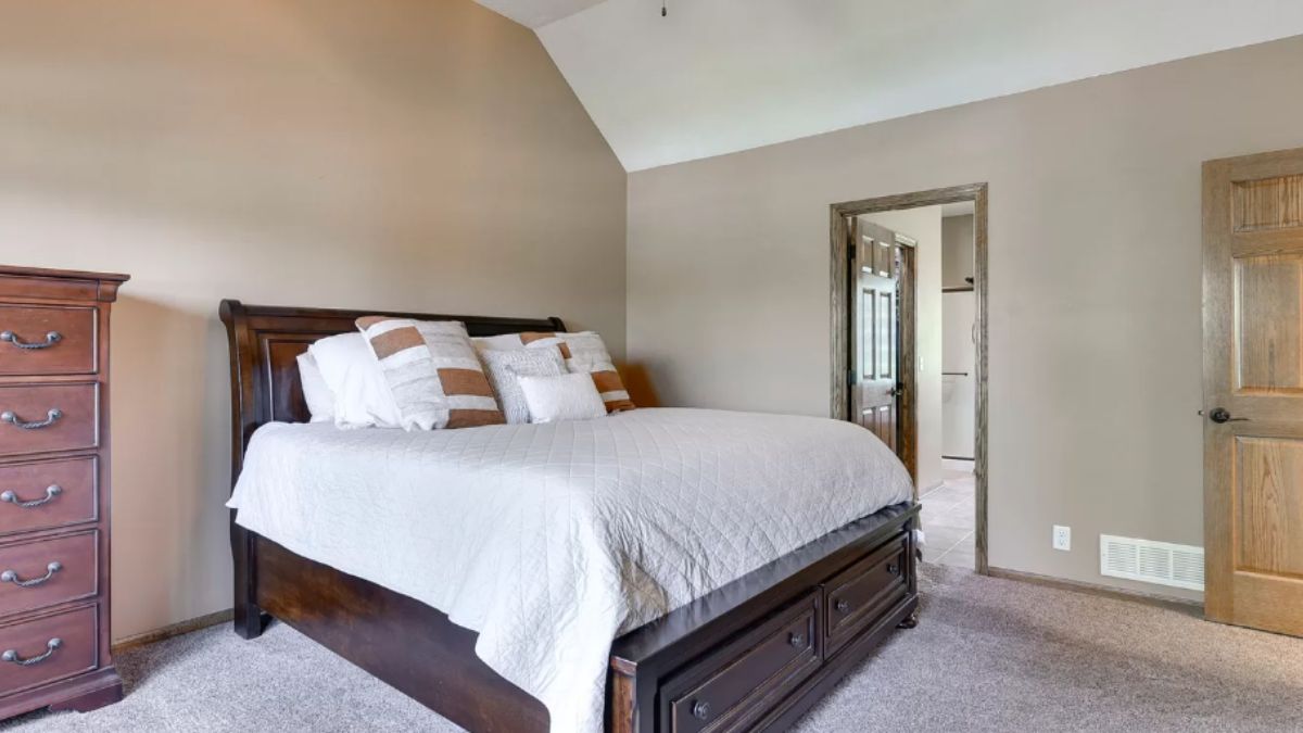 A bedroom with a bed and a cabinet.