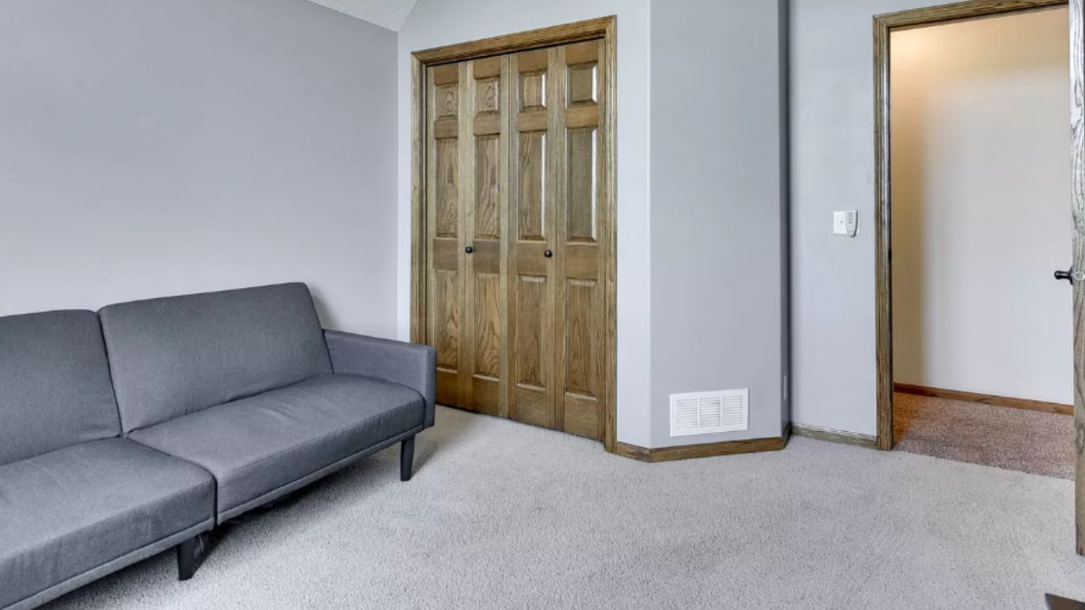 A seating area with a gray couch.