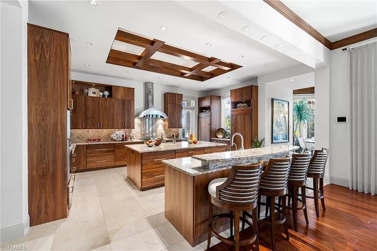 Kitchen with a spacious granite counter breakfast bar and a center island prep area.