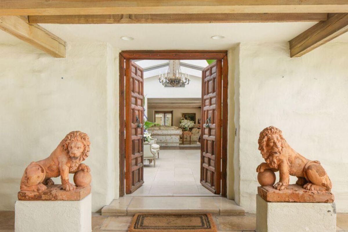 A front entry with two lion statues.