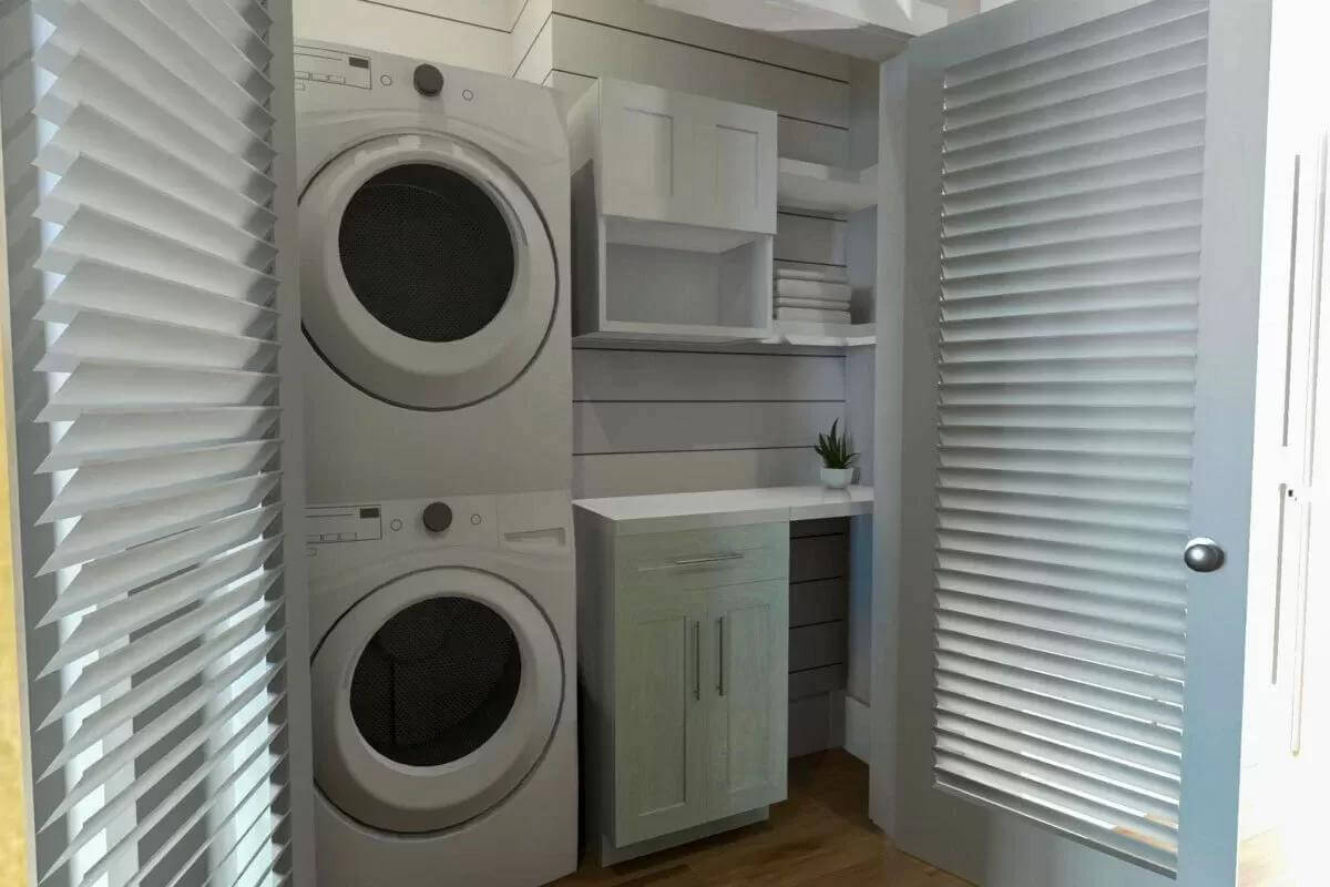 Laundry room with a stacked washer and dryer, a marble counter, and overhead cabinets.