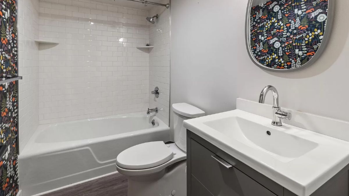 A bathroom with a vanity, toilet, and bathtub.