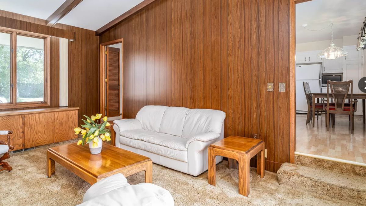 A family room with a window, cabinet, couch, and a center table.