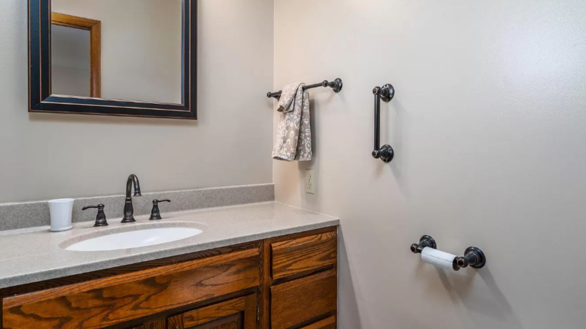 A bathroom with a vanity and a mirror.