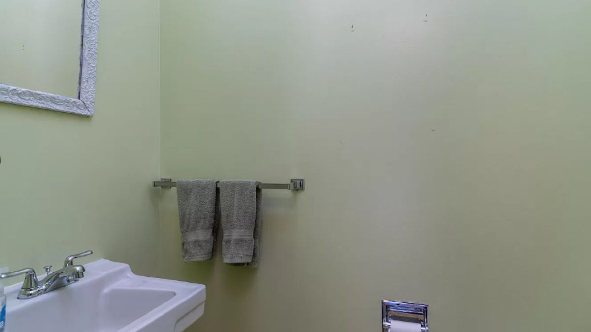 A bathroom with a vanity and mirror.