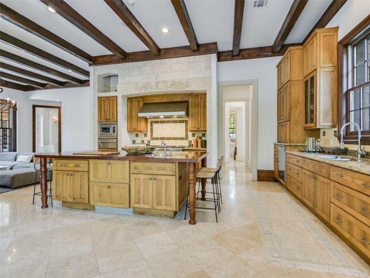 Kitchen with stainless steel appliances and center island prep area.