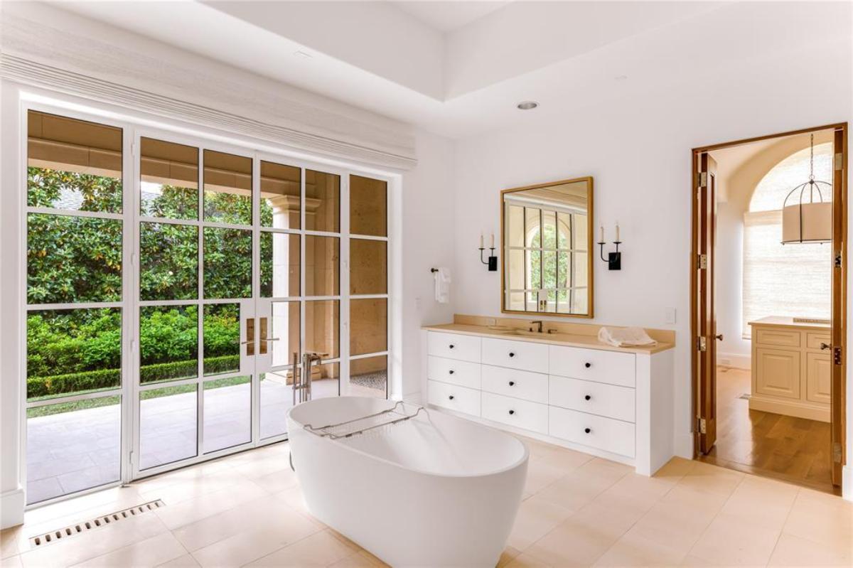 Bathroom with a soaking tub and a walk-in closet.