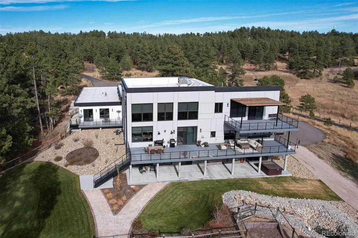 Aerial rear view of the contemporary mansion.