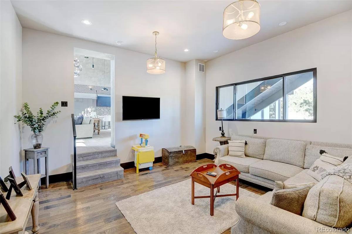 Family room with an L-shaped sectional and a wall-mounted TV.