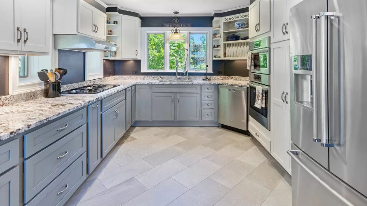 A kitchen with countertops, sink, cabinets, and kitchen appliances.