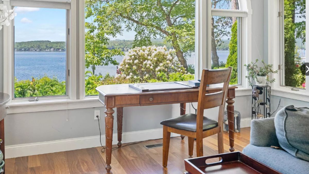 A home office with a window, desk, and chair.