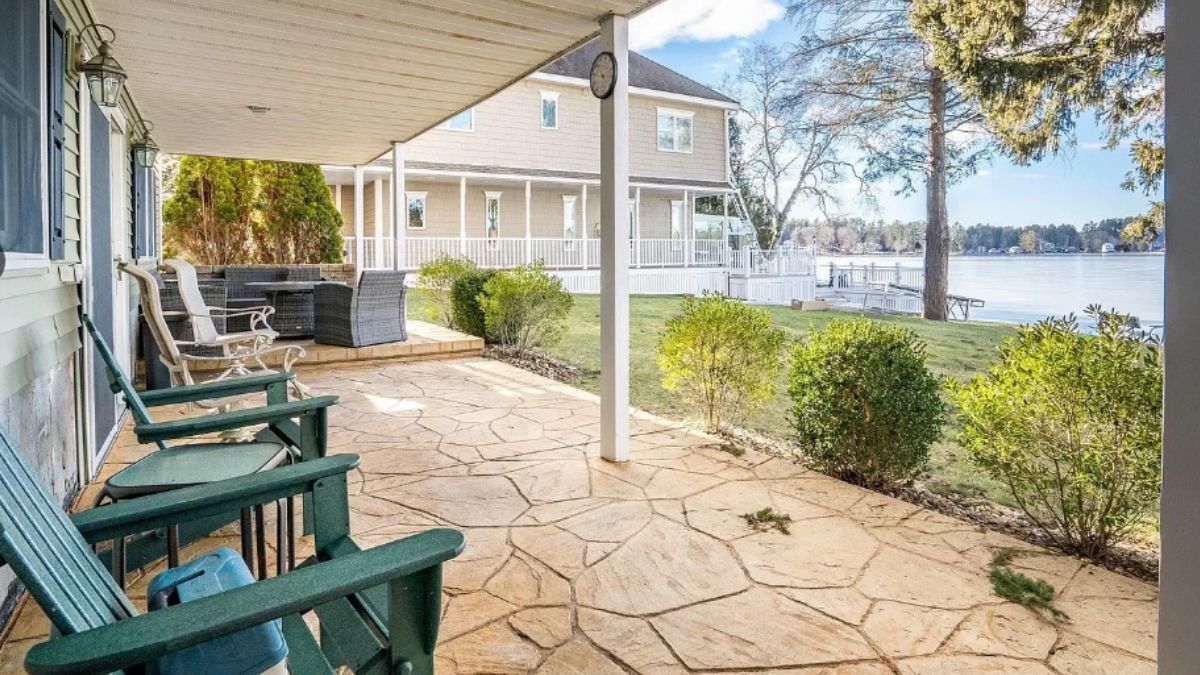 A porch with chairs and a coffee table.