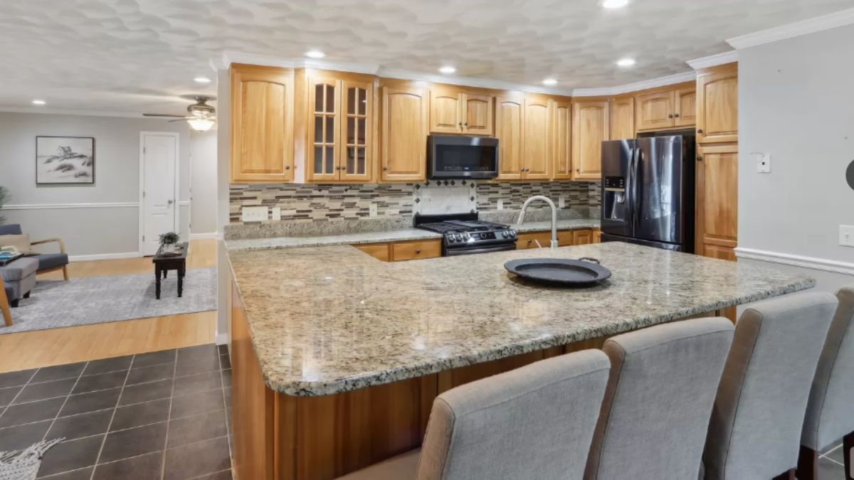 A kitchen with countertops, a sink, cabinets, and kitchen appliances.